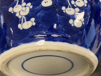 A pair of large Chinese blue and white 'prunus' jars and covers, 19th C.